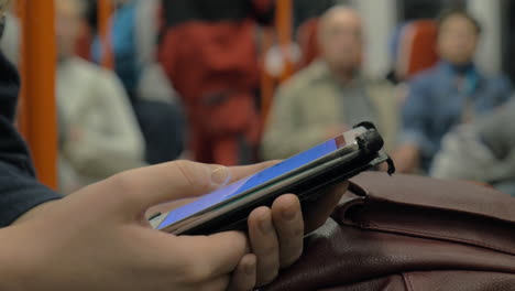 surfing internet on cell in underground train