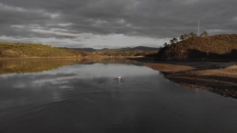 Canoeist-paddling-leisurely-up-Mira-river,-Portugal