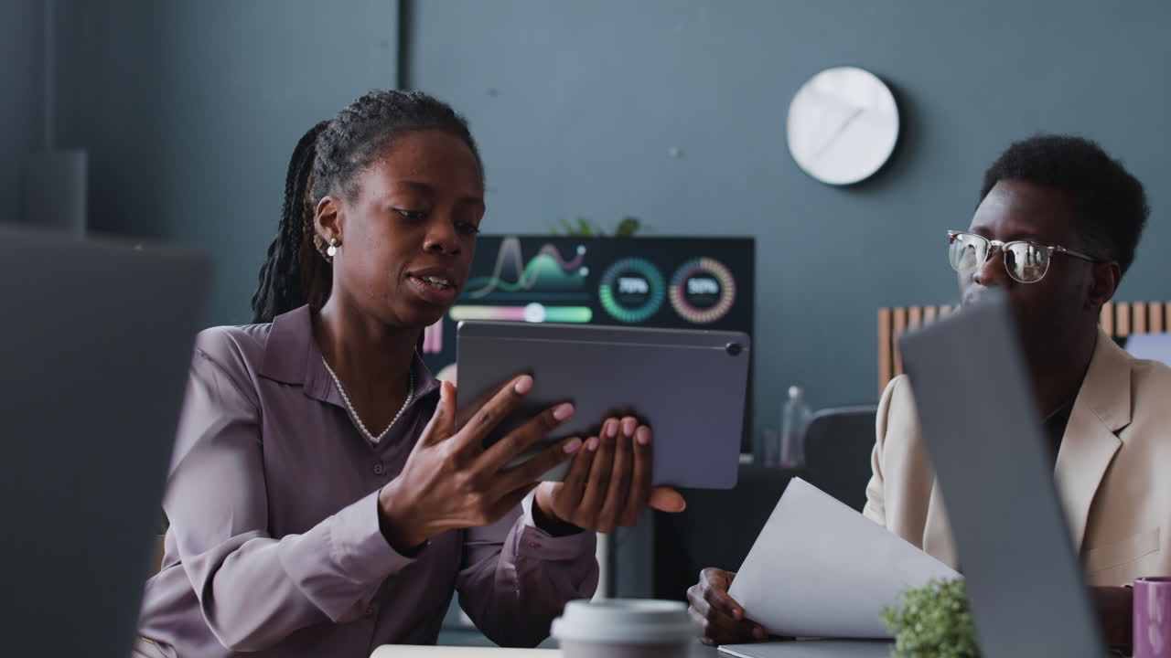 Business Colleagues Collaborating on Tablet in Modern Office