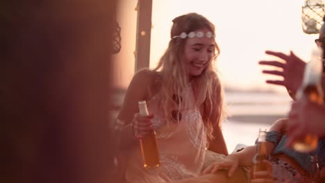 young multi-ethnic friends drinking beer at summer island beach party