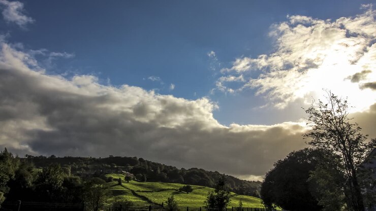 Typical english country side , rolling hills , trees and epic clouds