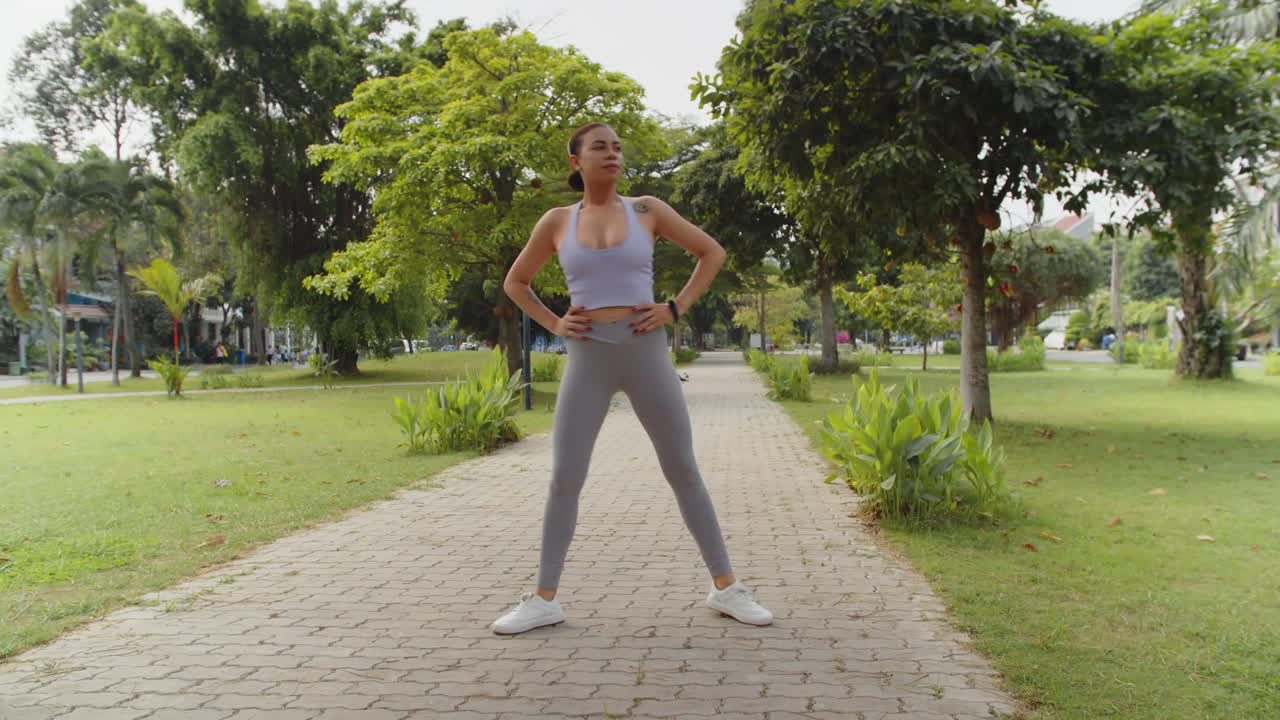 Young Girl Doing Lunges when Working out in City Park