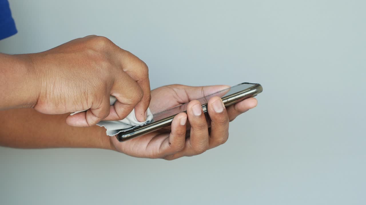 Cleaning a phone screen with a tissue