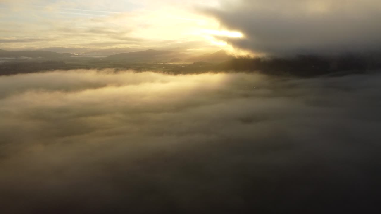 US, OR, Salem, 2025-11-24 - Drone view rising through the dawn mist and clouds of the Wilamette Valley in fall