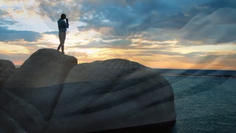 animation of flag of argentina over african american woman at beach