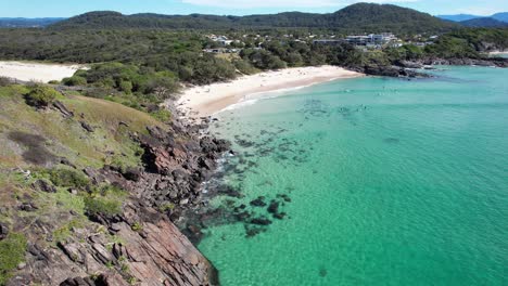 beachgoers enjoying the crystal clear turquoise waters of cabarita beach, tweed shire, bogangar, northern rivers, new south wales, australia aerial shot