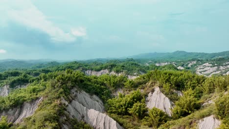 drone approaching flight over green moon world landscape of taiwan during cloudy day