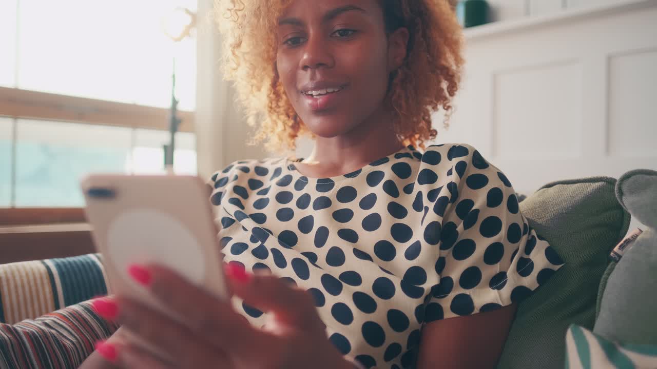Satisfied stylish dark skinned female blogger during live show thumbs up
