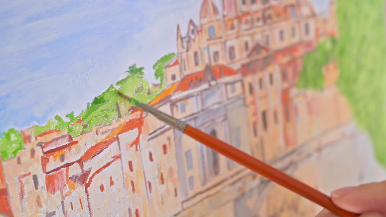 Female hands painting a picture