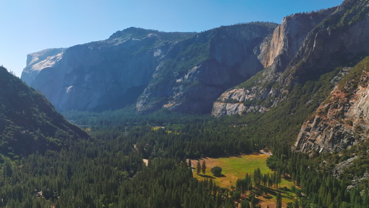 Sunny valley with pine tree wood among the rocks of Yosemite National Park, California, USA. Stunning picture of amazing nature from top view.