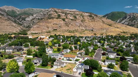 The Pleasant Grove neighborhood, formerly known as Battle Creek, Utah with the G for Grove visible on the mountain - ascending aerial reveal
