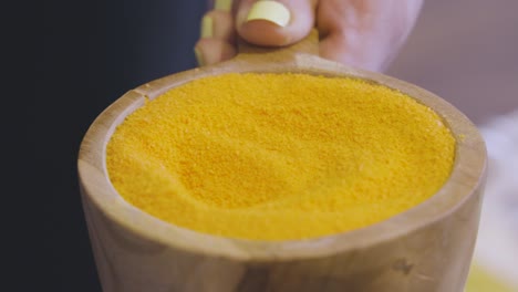 scooping powder in preperation for a refreshing foot bath at the beauty salon