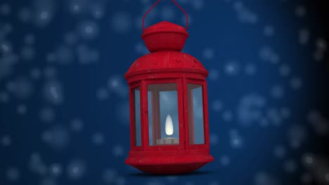 red christmas lamp against white spots falling on blue background