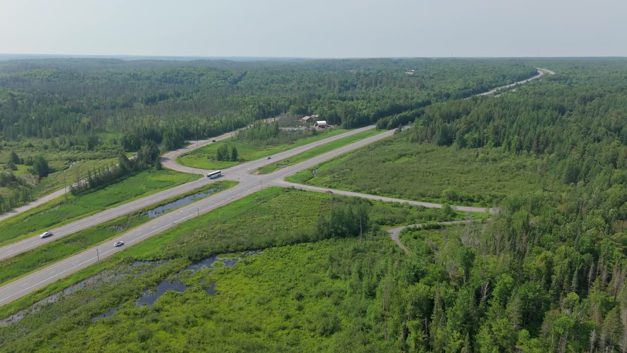 Aerial above Highway 11 in Muskoka with forest and countryside