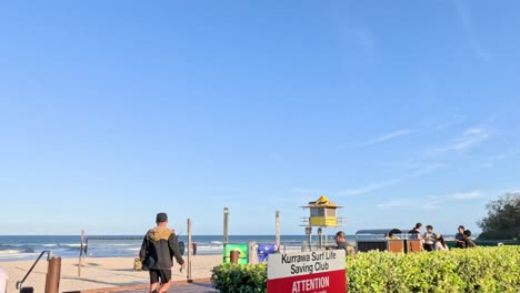 people enjoying a sunny day on a coastal walkway