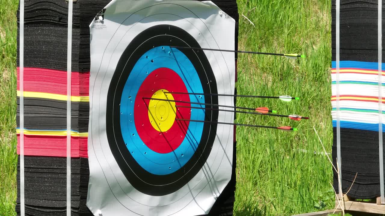 Archery arrows hitting target and bullseye with consistency, closeup of target