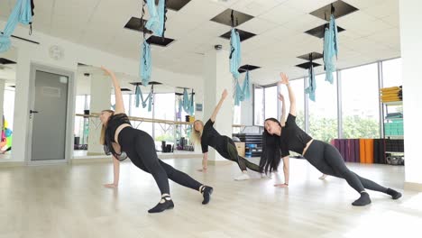 women participating in a group fitness class showcasing teamwork and motivation in a vibrant studio women participating in a group fitness class showcasing teamwork and motivation in a vibrant studio