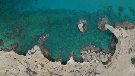 aerial view of turquoise sea waters and rocky coastline