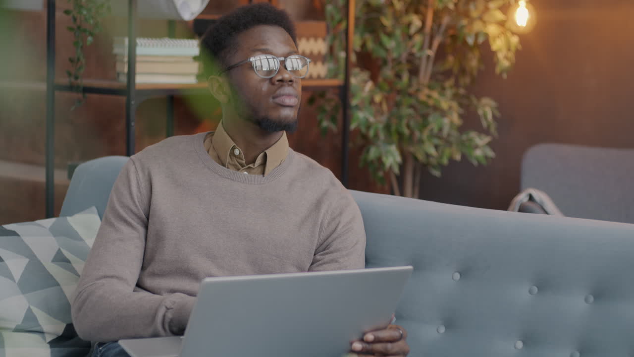 Man working on a laptop at home or in a cafe