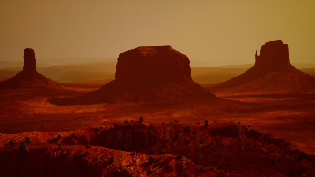 Sunset over monument valley with red rock formations and desert landscape