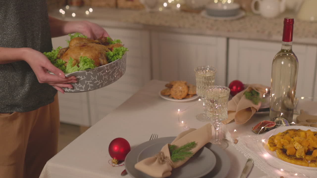Unrecognizable Woman Putting Roast Chicken On Christmas Dinner Table 3