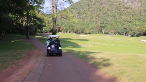 golf cart driving along a path on a sunny day