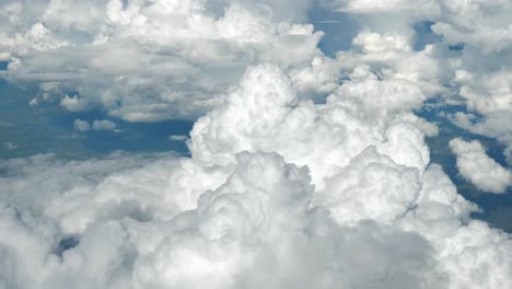 View-from-airplane-window-with-clouds-and-land