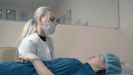 woman talks with girl client about brow tattooing procedure