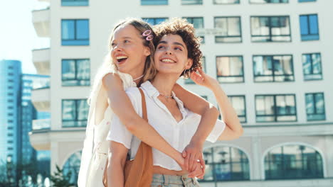 two happy women hugging outdoors