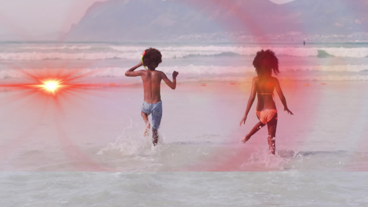 Running into ocean waves, people with glowing animation effect on their backs