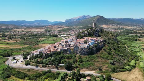 Posada-Village-and-Tower-on-Top-of-a-Hill-at-Sardinia,-Italy---Aerial-4k