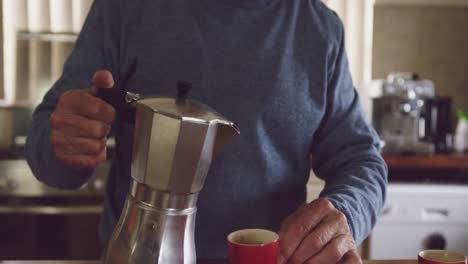 senior man drinking coffee at home