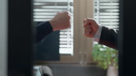 businessmen exchange a dap handshake behind office doors, modern confidence, camaraderie, and urban professionalism. fresh take on business, partnerships, corporate culture. stylish, energetic vibe.