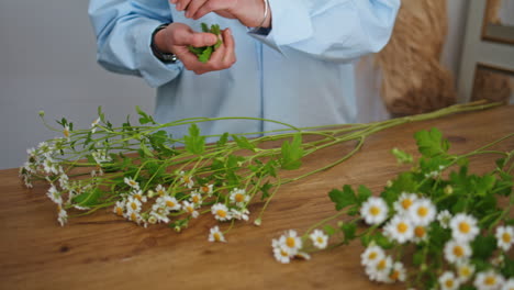 closeup florist seller hands work make beautiful flower bouquet in business shop