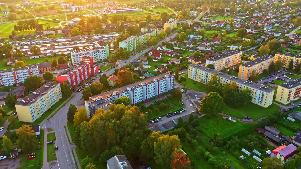Residential Area With Colorful Multi-story Apartment Blocks in Golden Hour Glow in Aerial View