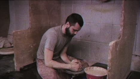 the potter makes a jug of clay. vintage effect. a man makes a vase on a potter's wheel