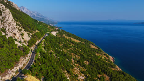 Aerial-view-following-a-mountain-road-on-the-Makarska-riviera-in-sunny-Croatia