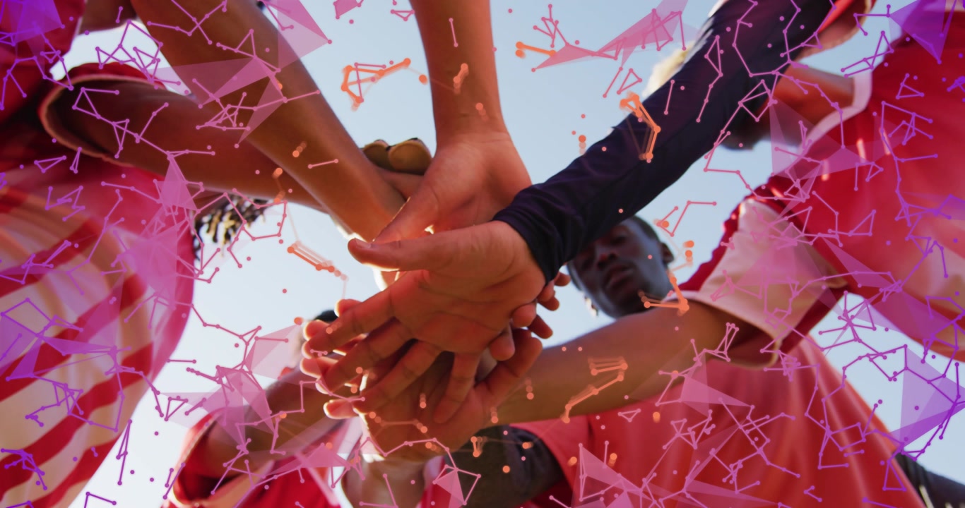 Sports team extending arms stacking hands initiating purple orange network overlay enhancing unity
