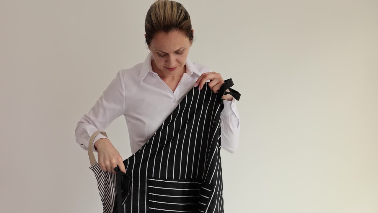 Woman comparing different striped aprons