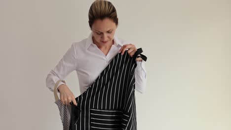 woman comparing different striped aprons