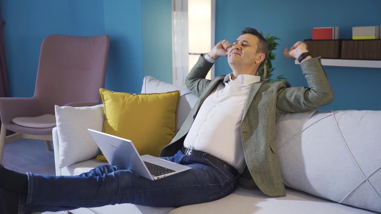 Happy man resting and finding peace at carefree calm home.