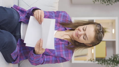 vertical video of the woman who rejoices in good content paperwork.