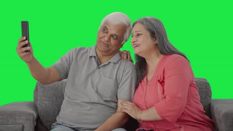 Happy-Indian-old-couple-clicking-selfies-Green-screen