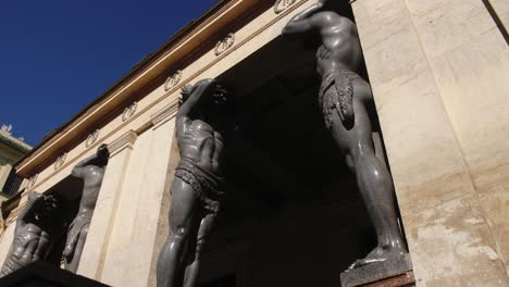 ancient stone statues at the entrance of a building