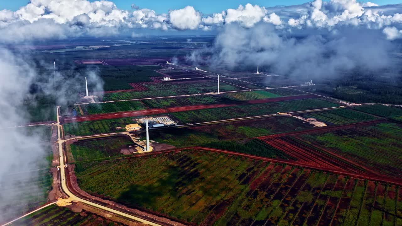 Wind farm in the countryside under cloudy skies, showcasing renewable energy
