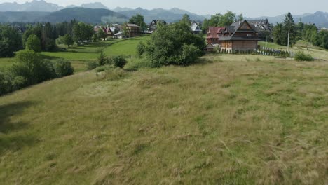 Beautiful-traditional-Polish-village-reveal-with-alpine-mountains-landscape-backdrop