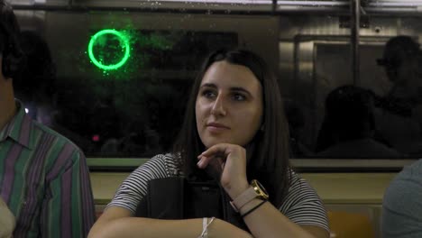slow motion of female sitting in moving train on new york subway system, usa