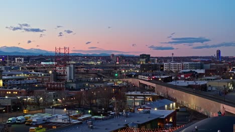 String-lights-hang-over-shops-as-Denver-suburb-glows-at-dusk-with-orange-sunset