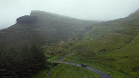 driving a car in an epic scenery in a fog day in the middle of the mountains in ireland