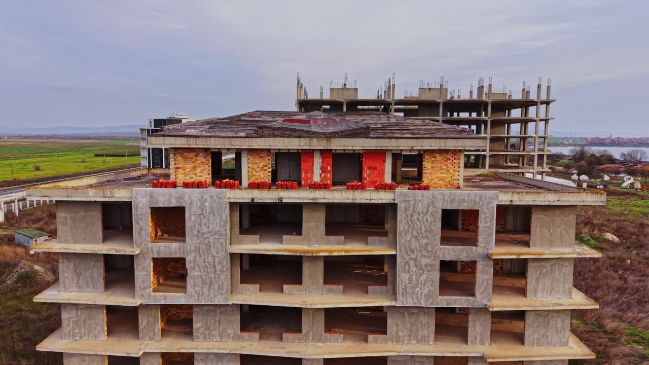 Abandoned construction site surrounded by fields in a rural area